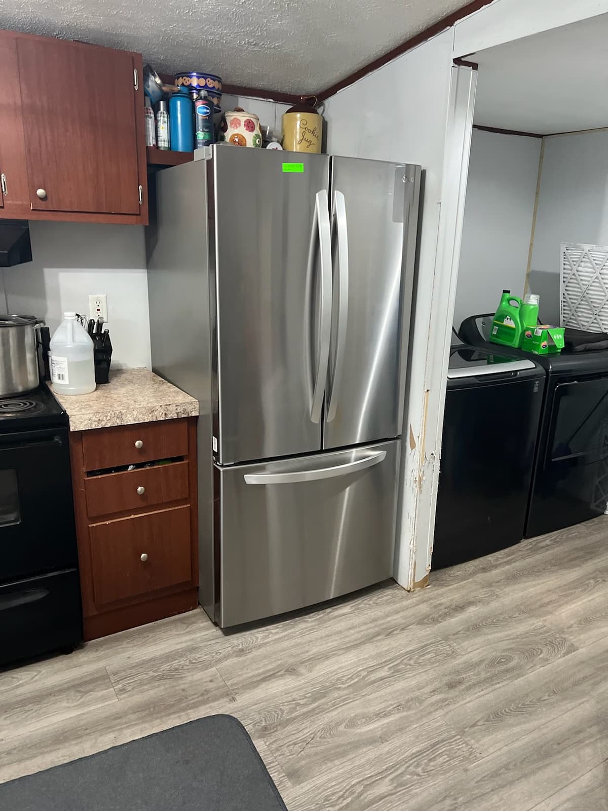 Stainless French-door refrigerator installed in a galley kitchen